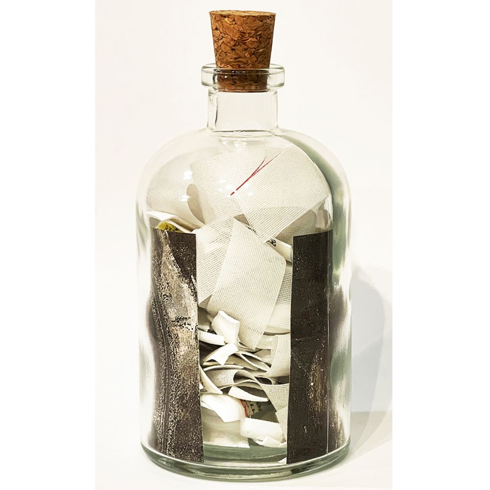 <br/>Molbo Praetorian back, 10/10/2025<br/>Apx 6½" x 3" x 3"<br/>glass, paper, ink, cork, plastic and cloth